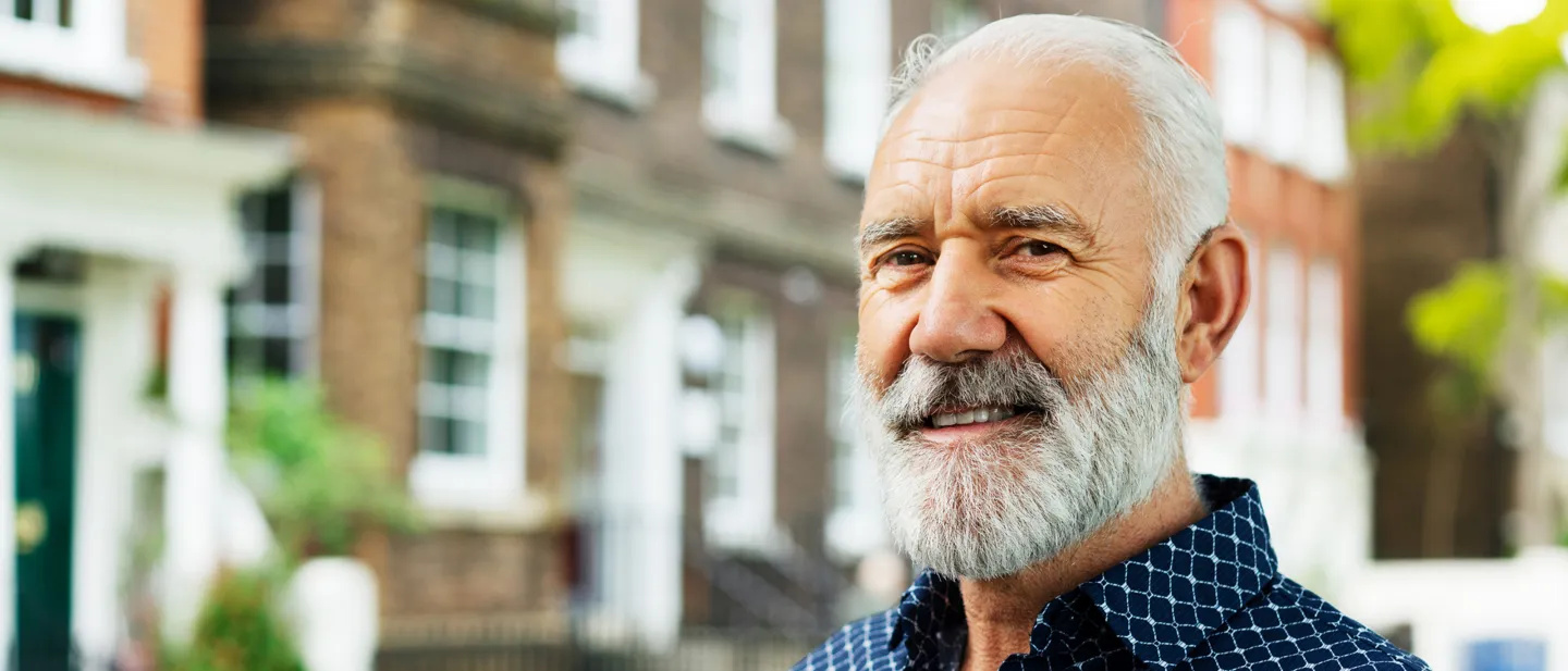 Bearded man standing in front of a building