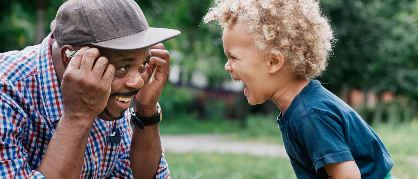a man making a child laugh