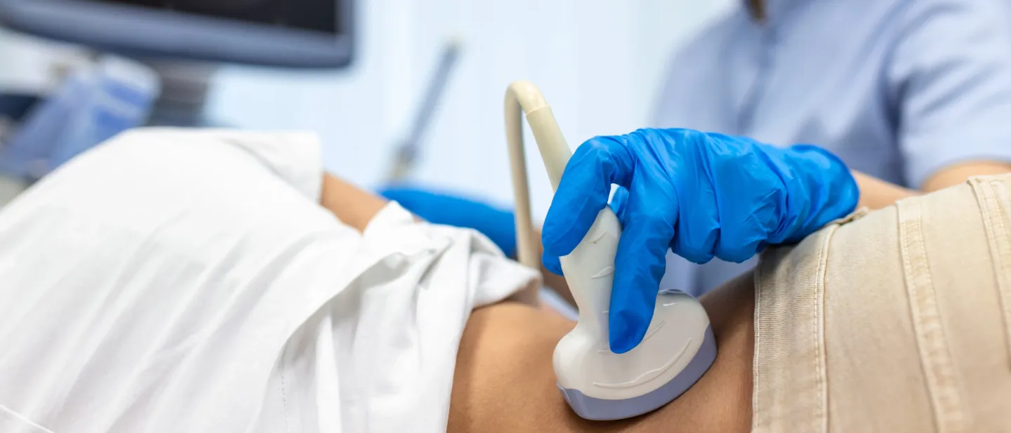 Technician using an ultrasound machine on a patient