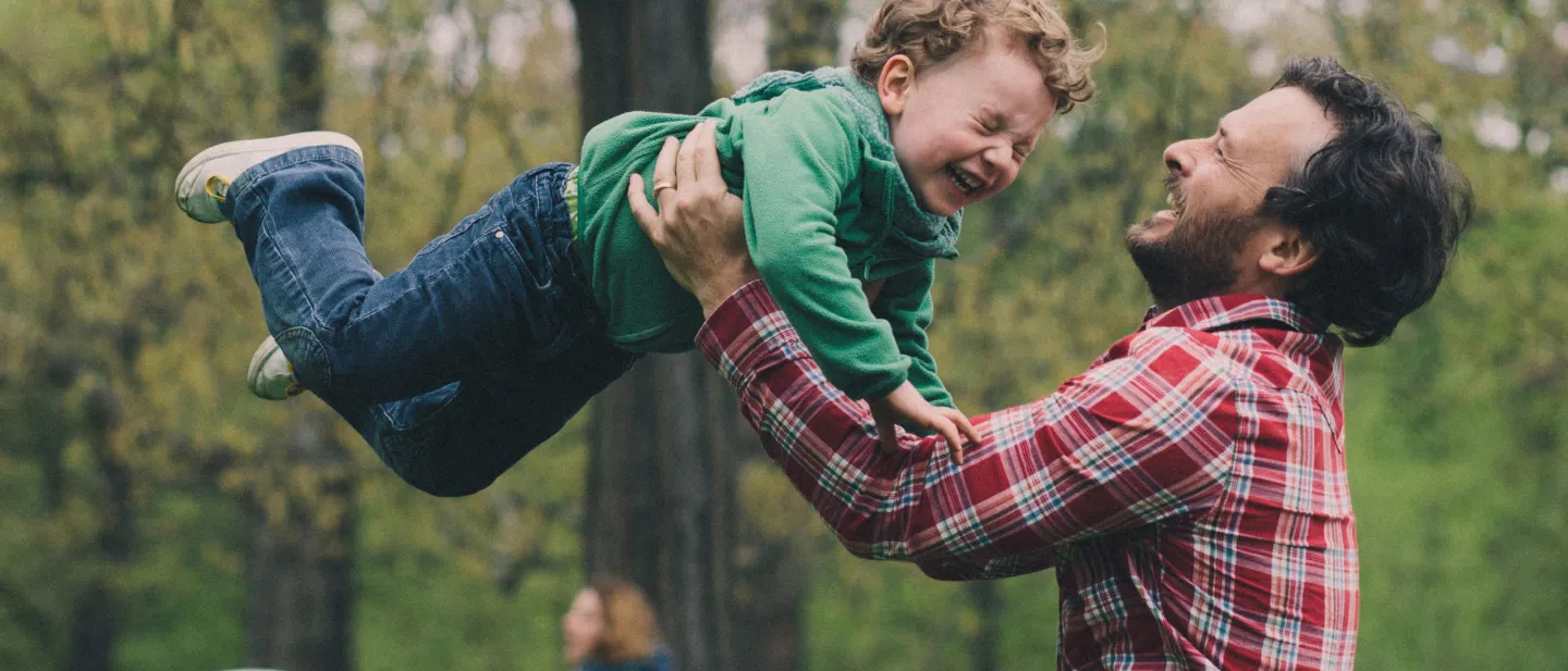 Father playing with young boy