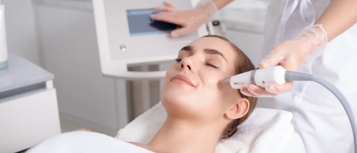 Relaxed and smiling woman on a table and receiving treatment