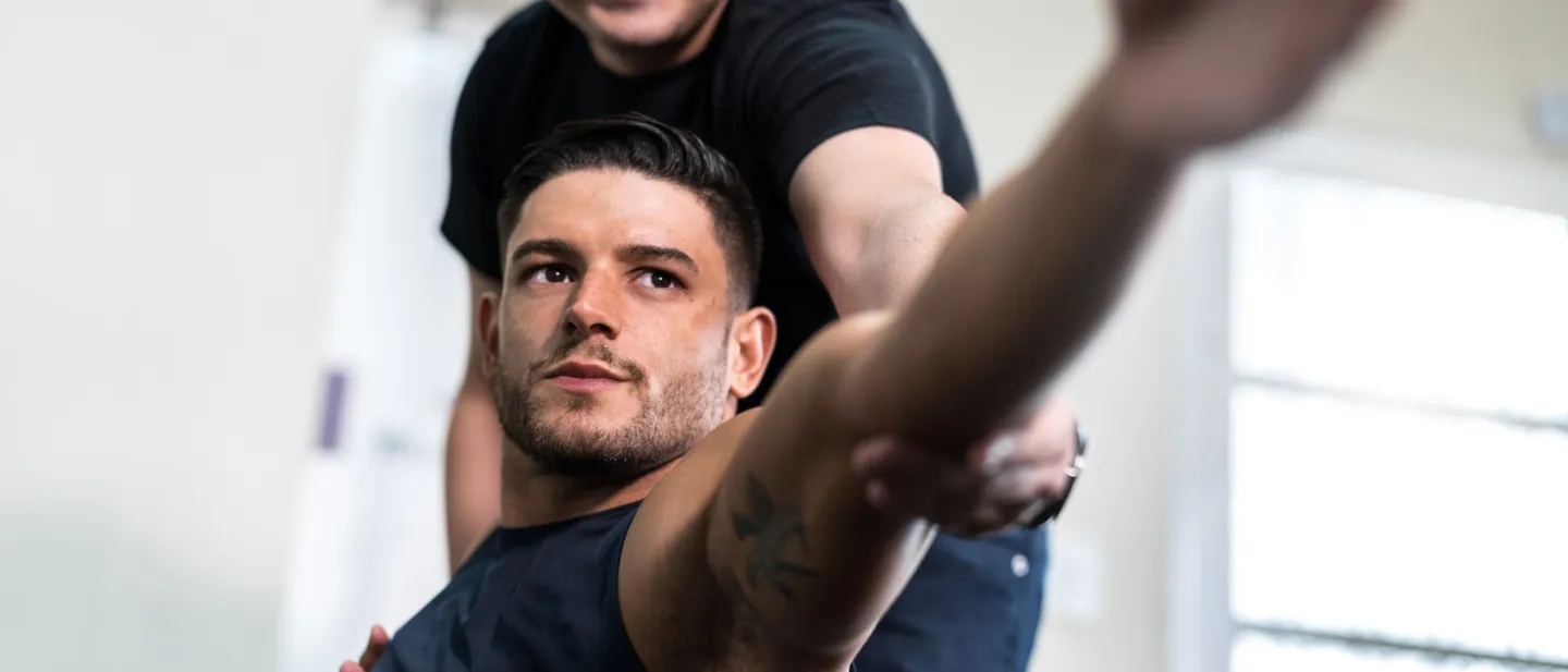 Man stretching with assistance