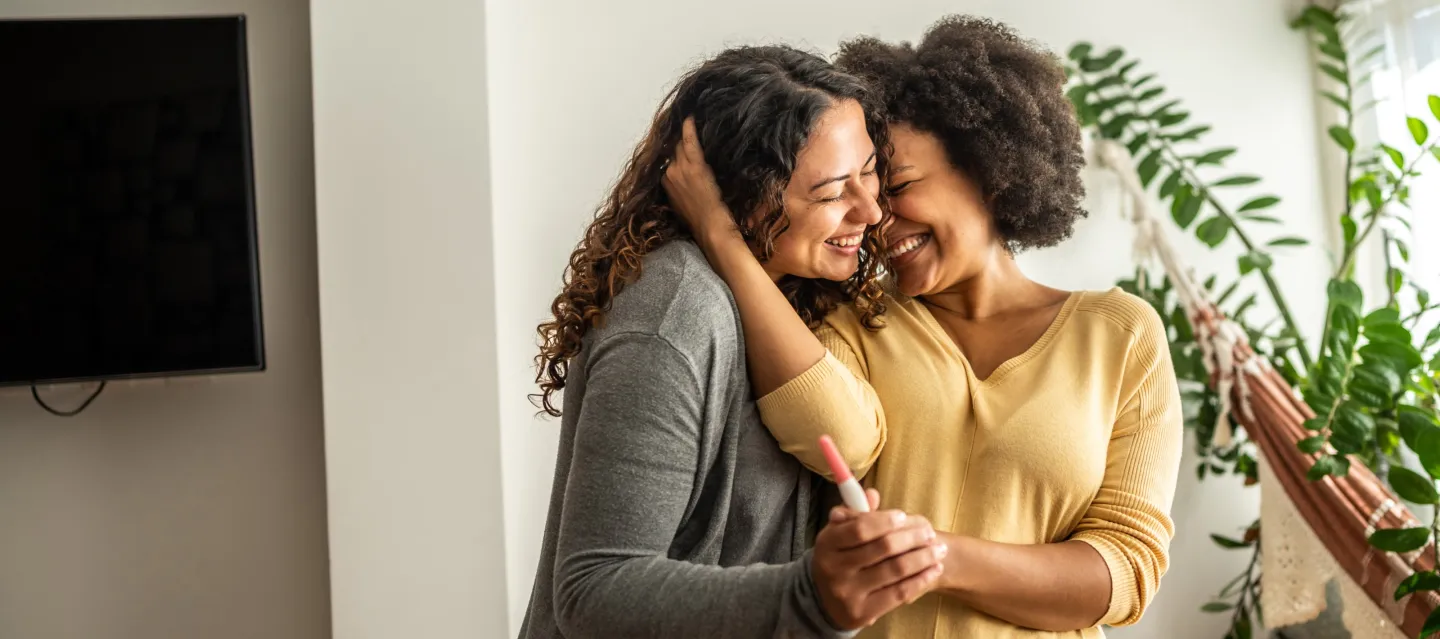 Two women hugging smiling