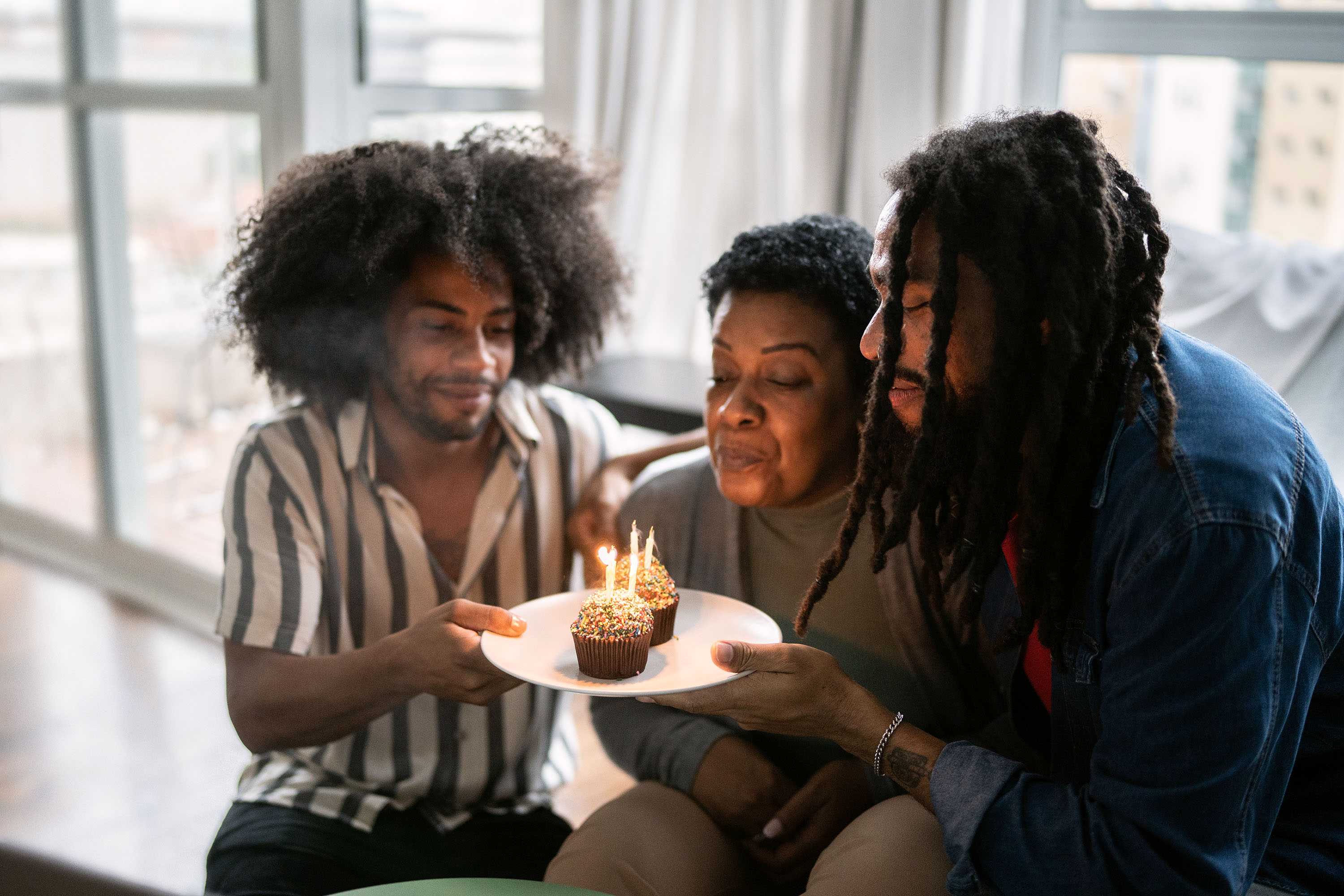 A family celebrating mother's birthday at home.