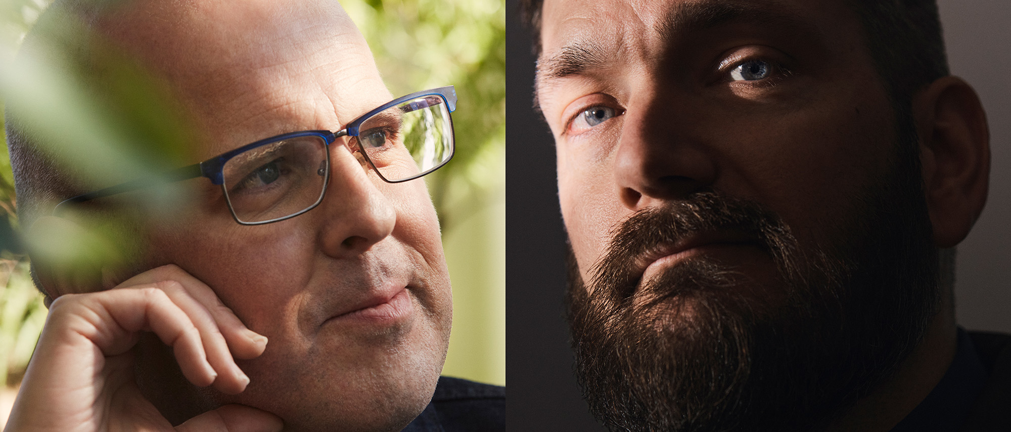 Man with glasses outdoors and man looking at camera.