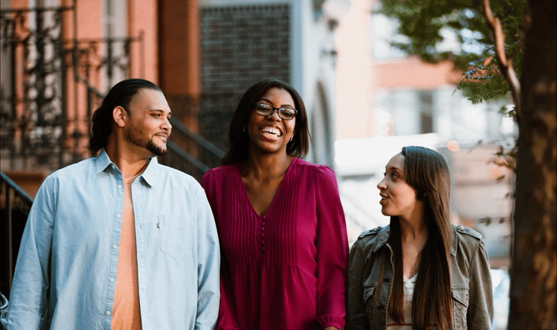 Erica and friends laughing on cafe sidewalk