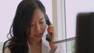 A young female doctor speaks on the telephone
