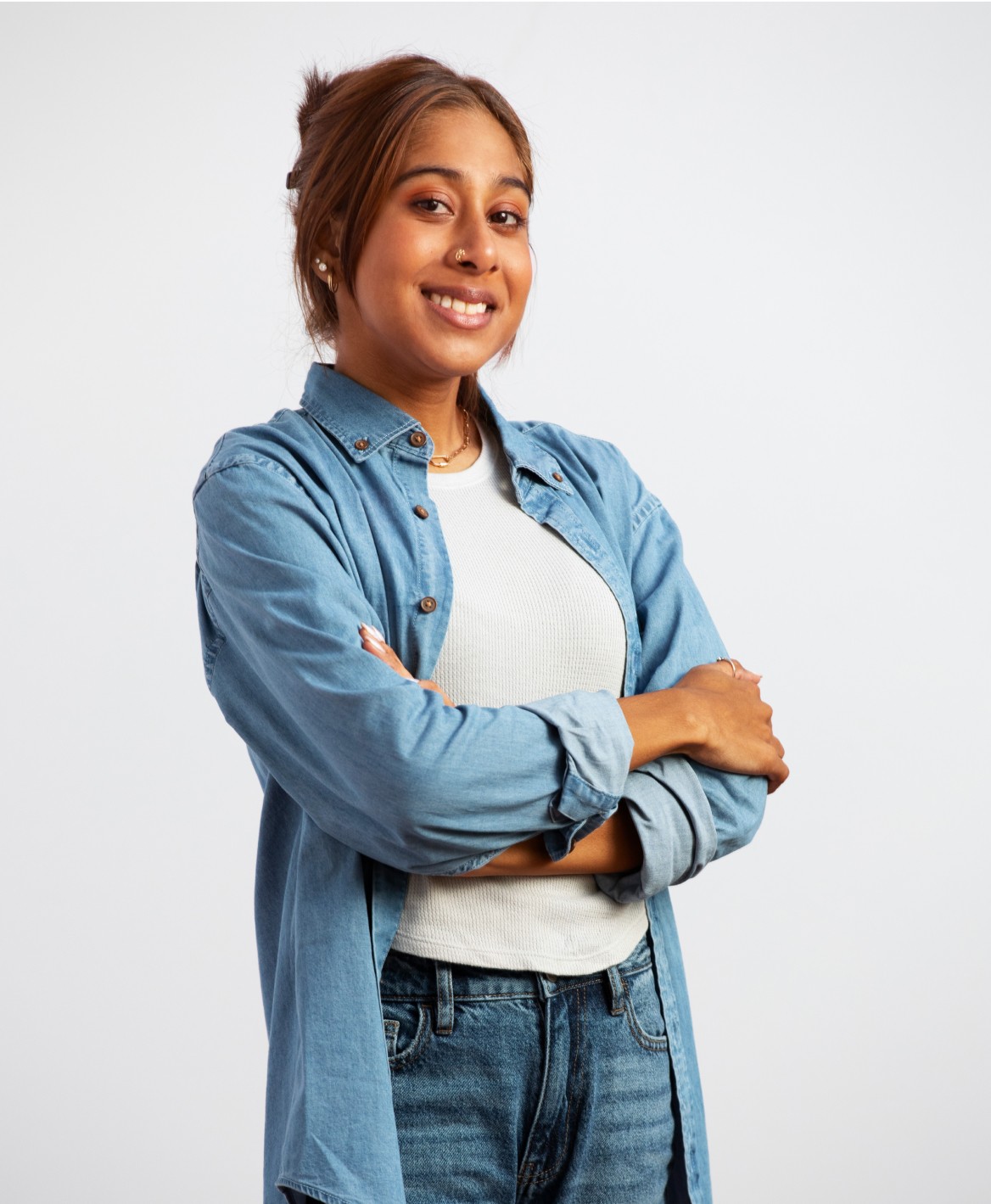 Alisha Khan smiling with arms folded