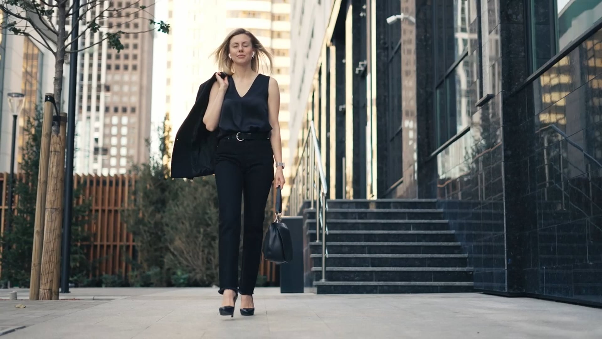 A woman in deep thought walking down a city street