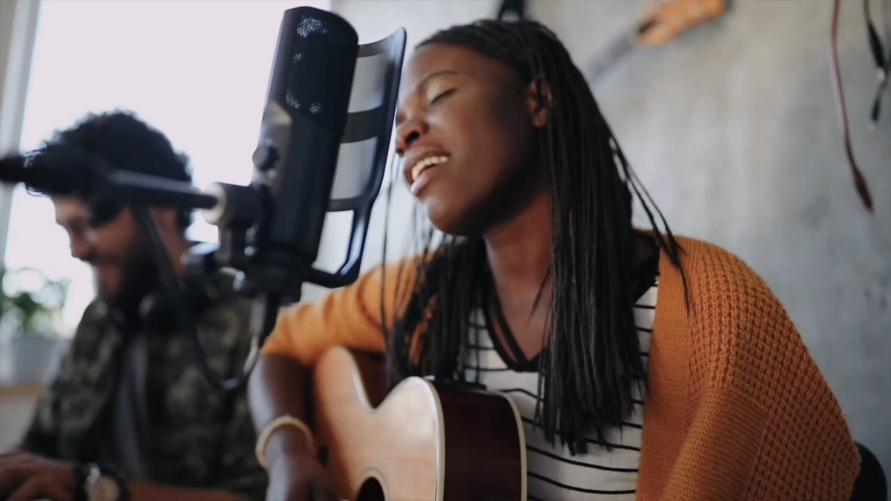 Woman playing guitar and singing