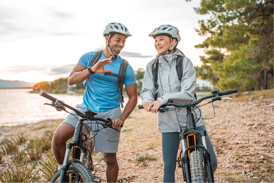 A man and a woman sitting on their mountain bikes