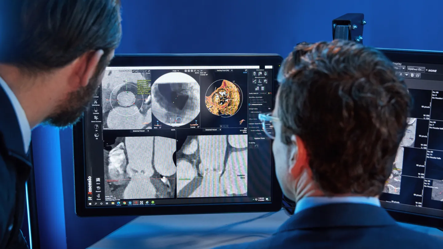 Dr. Leandro Slipczuk Bustamante and a colleague review the results of an echocardiogram on a computer monitor.