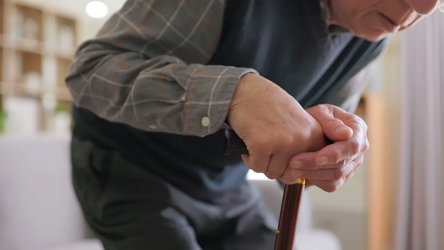 Elderly man having difficulty moving at home