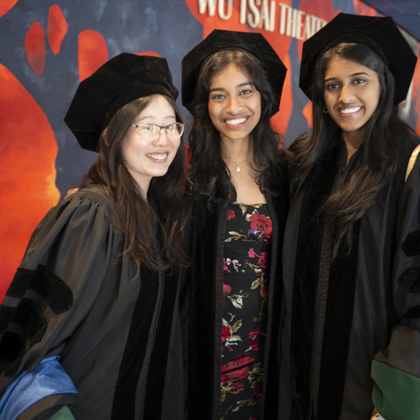 three female students at graduation