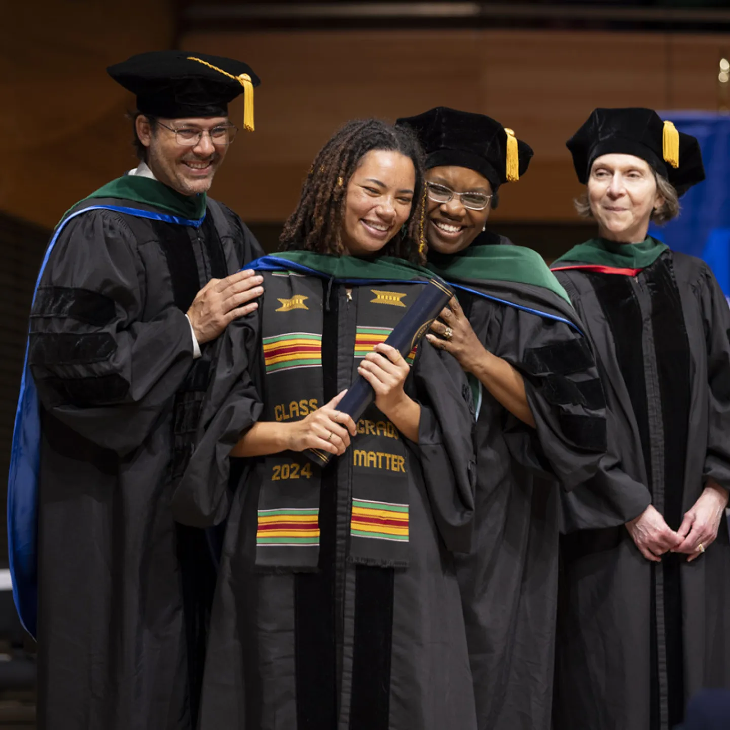 Student taking a picture with mentors 