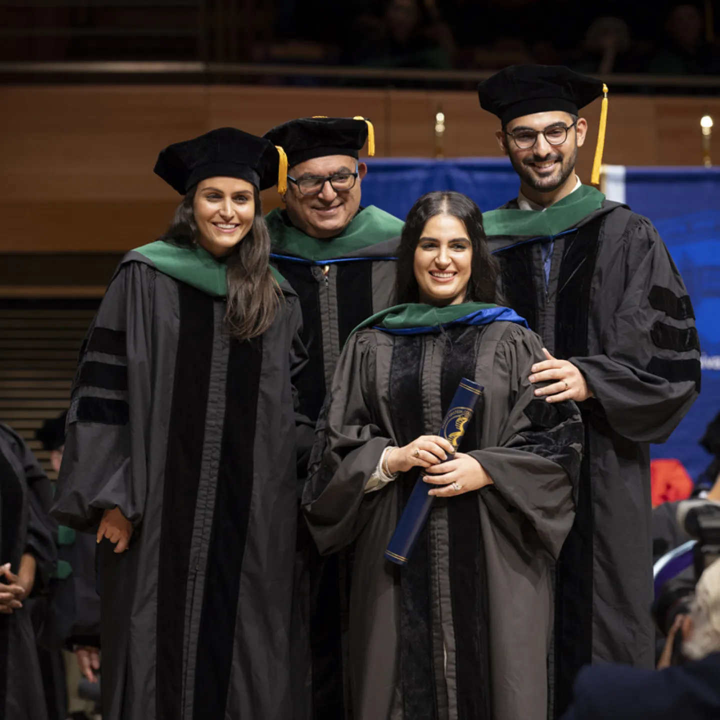 students posing for a picture with photographer