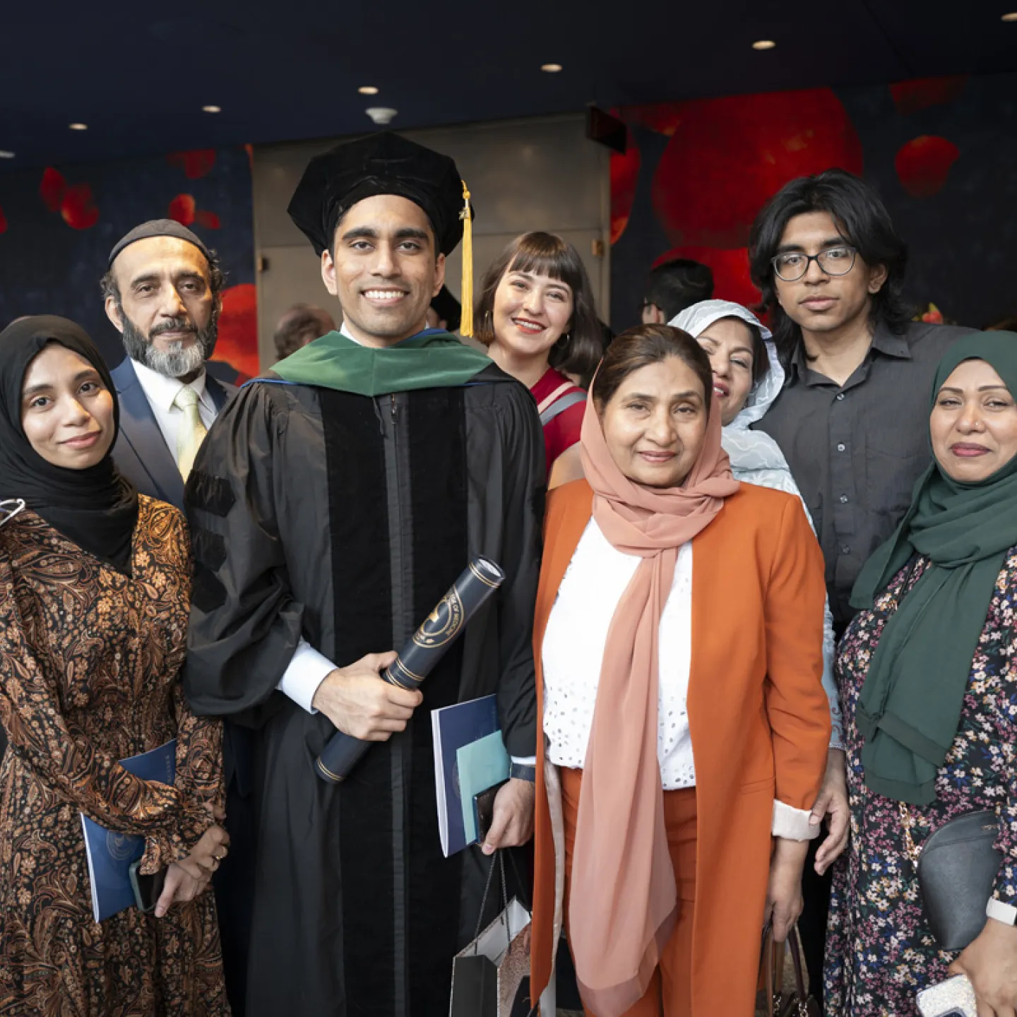 family taking photo with student