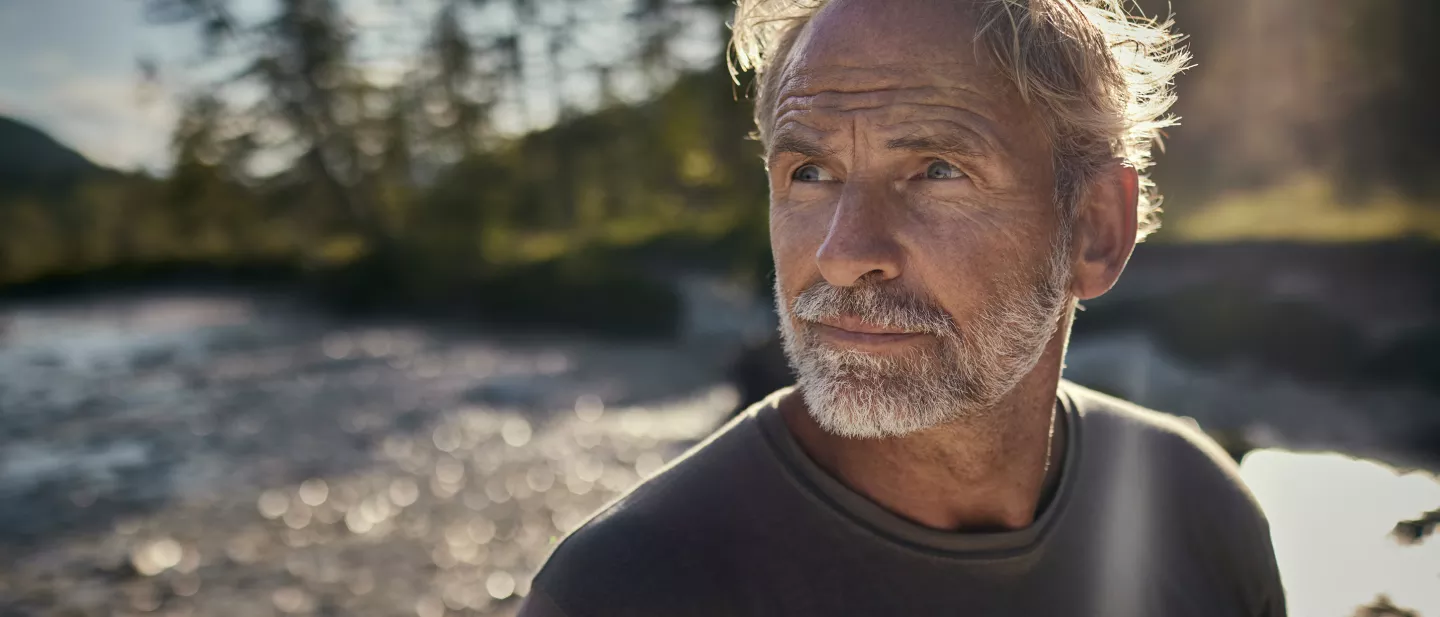 A man standing on a river bank