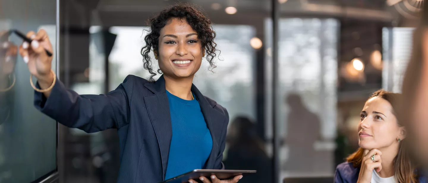 Businesswoman smiling while giving presentation with digital tablet