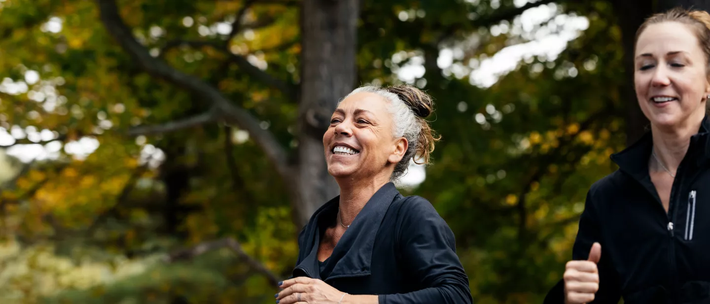 Laughing woman with red hair talking to someone at an outdoor café