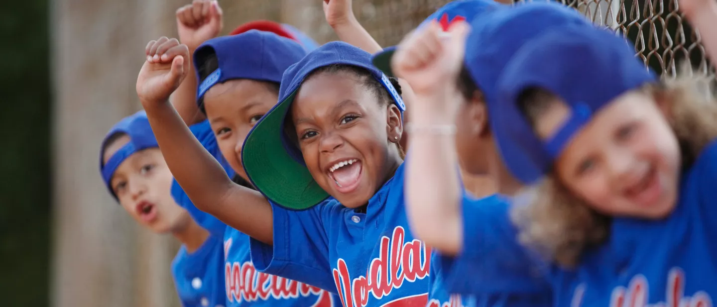 Little League baseball team cheering