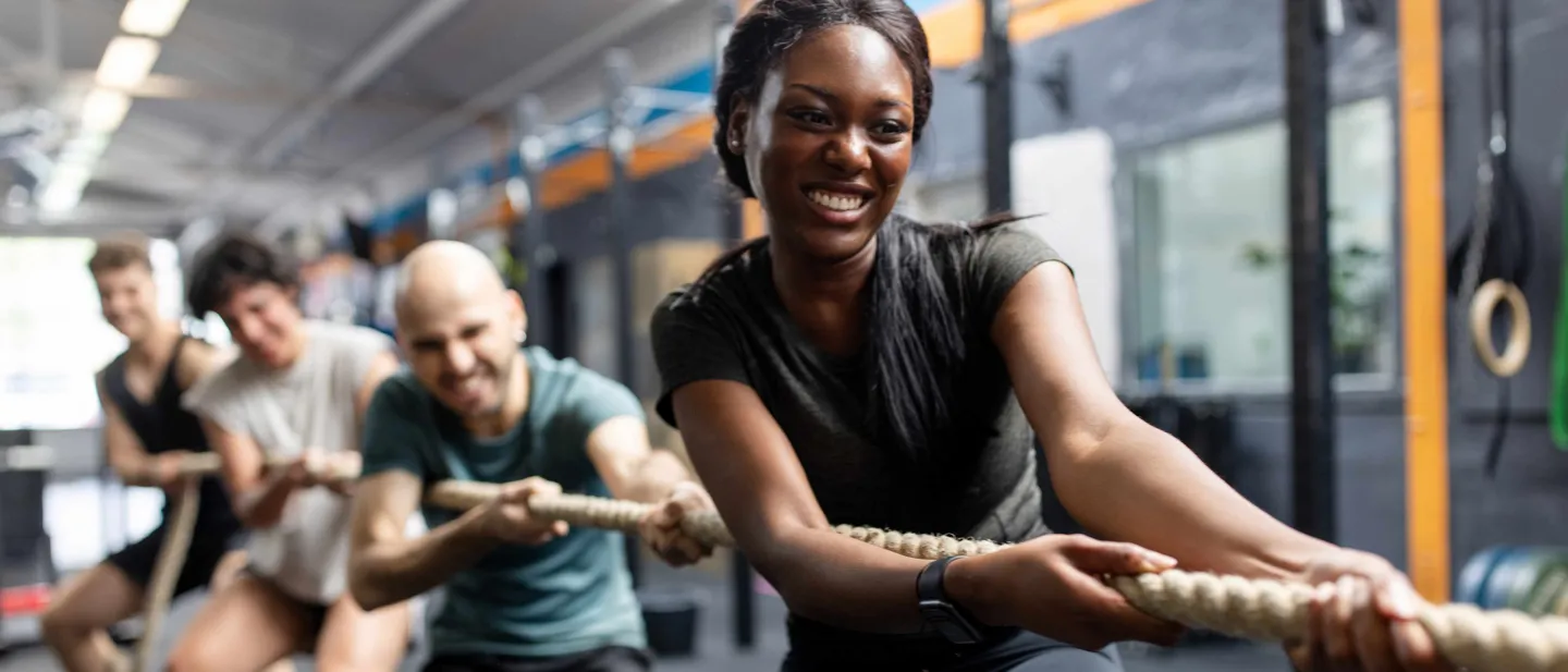 People playing tug war at a gym.
