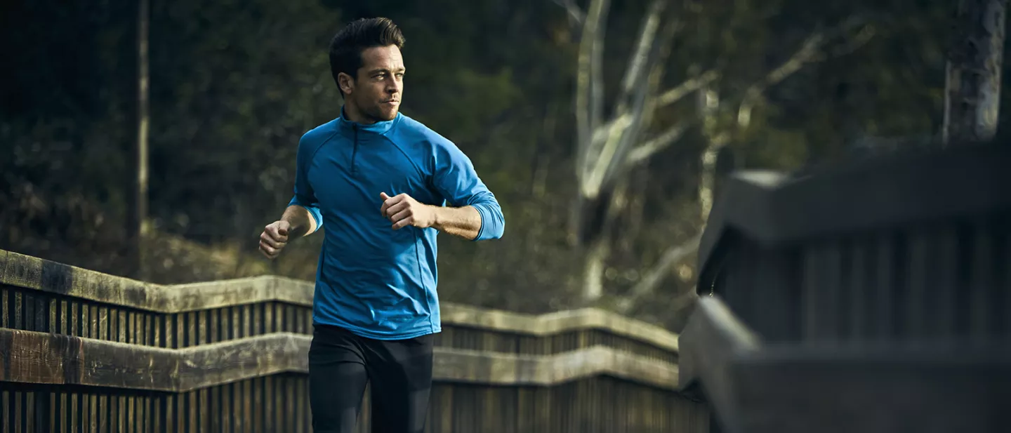 Man jogging through forest.