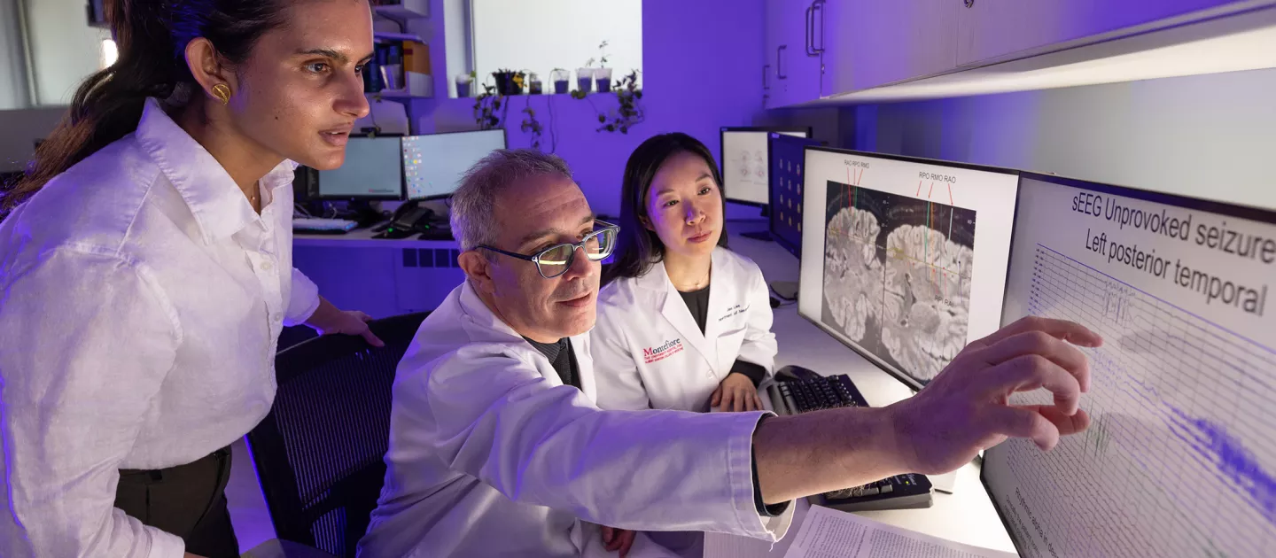 Fellows sitting with a physician looking at a screen