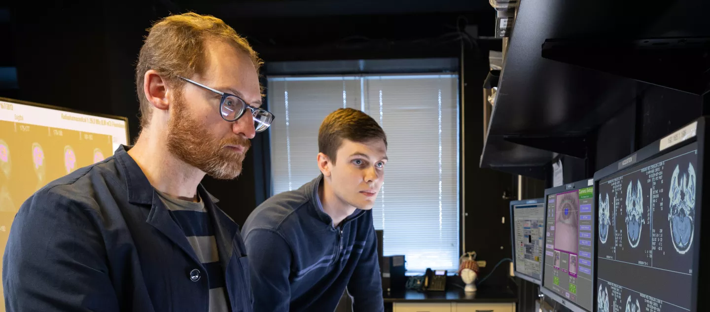 Two researchers working in a lab looking at computer screens
