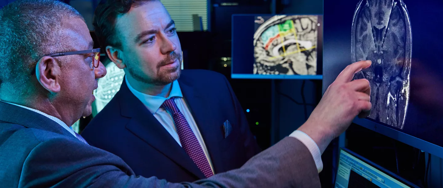 Researchers having a discussion and pointing to a computer screen