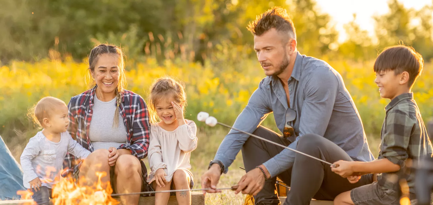 A family enjoying a campfire and roasting smores