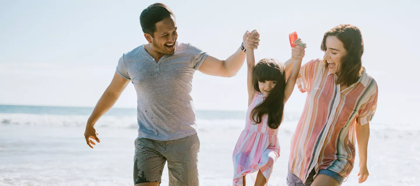 Loving family enjoying sun at the beach