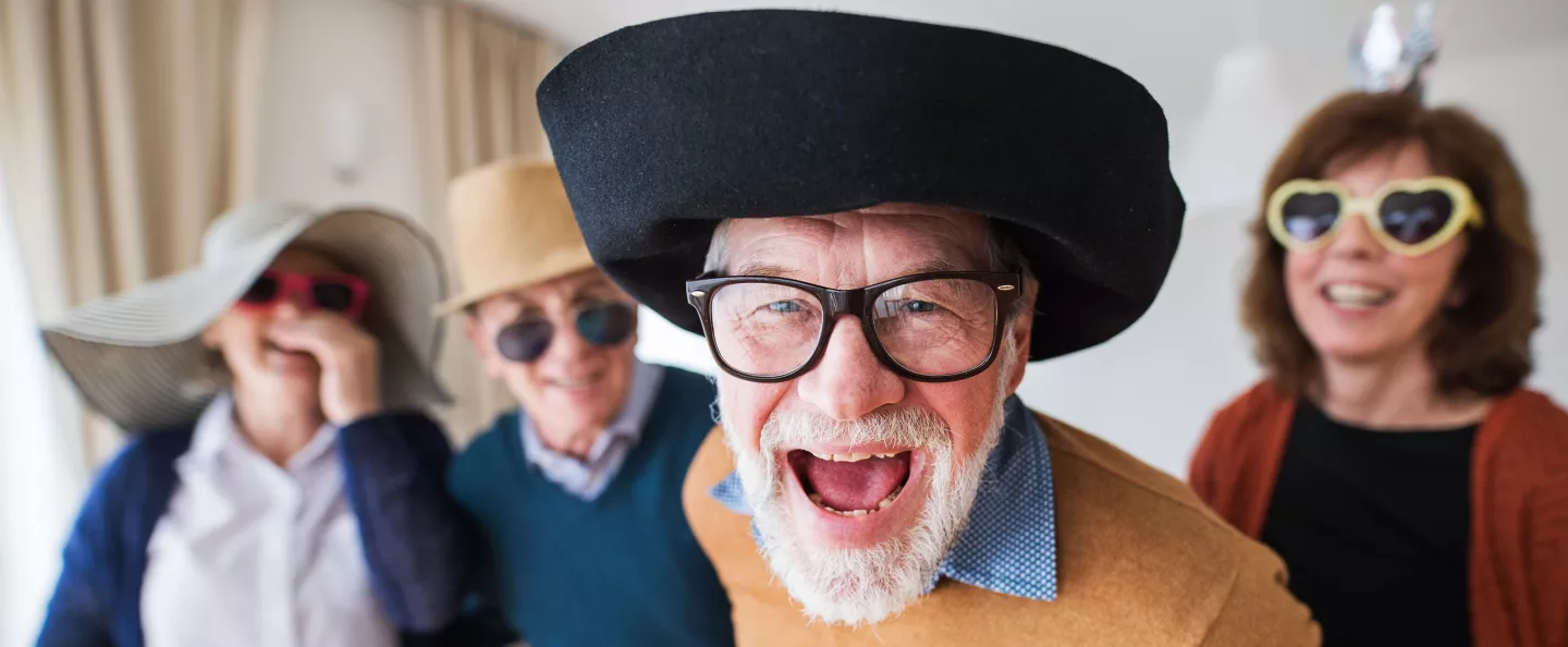 Two senior couples having fun at a party at home.