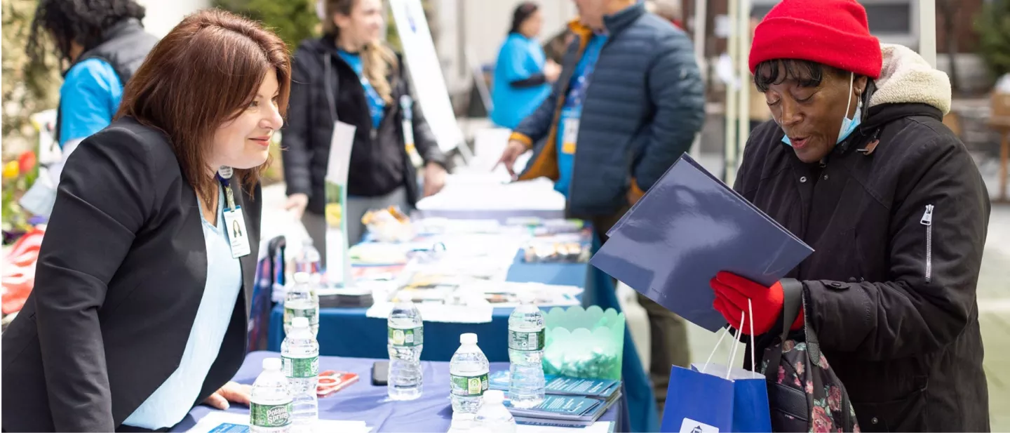 A woman reading a brochure at a community event