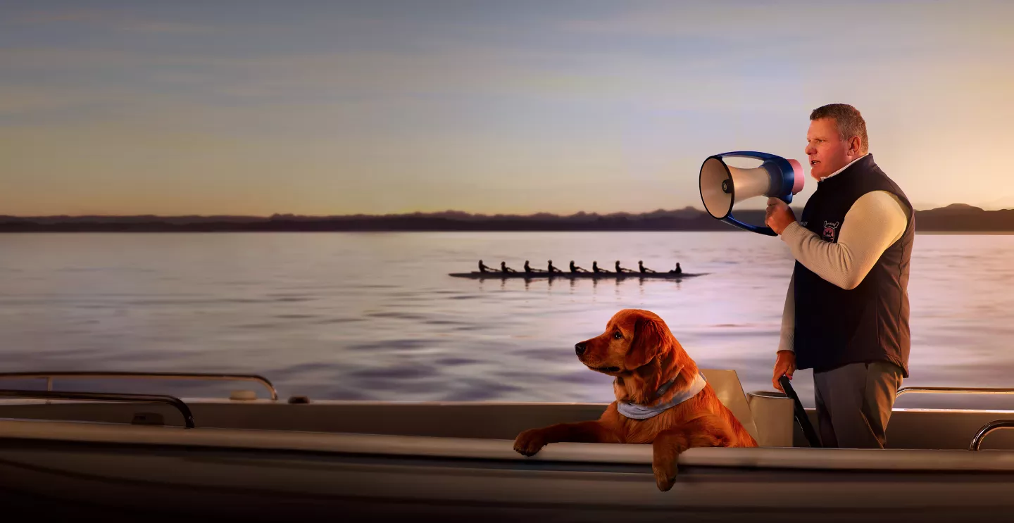 A man and his dog enjoying a boat ride together.