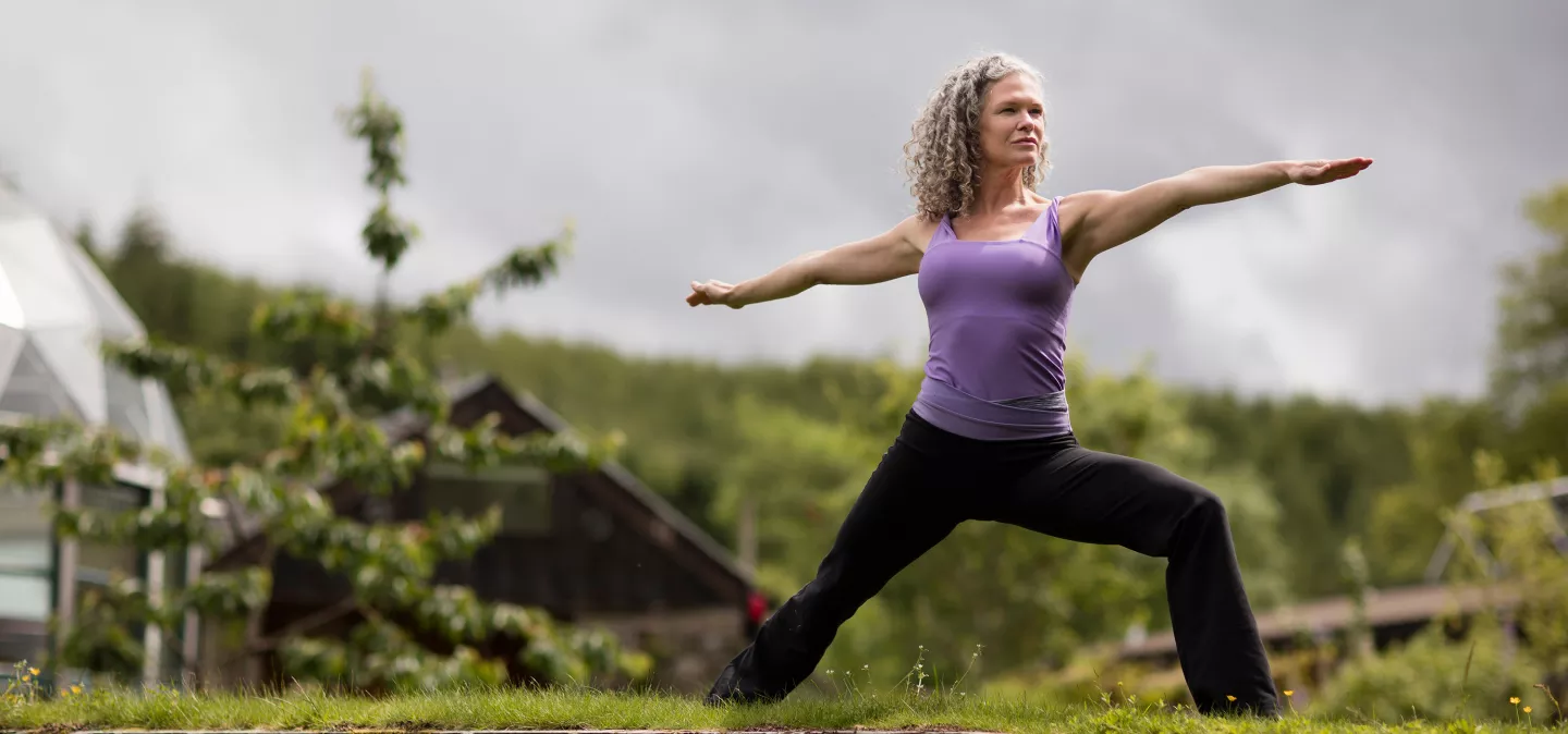 A woman practicing Yoga outside