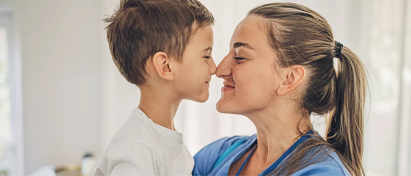 Female adult smiling touching noses with child