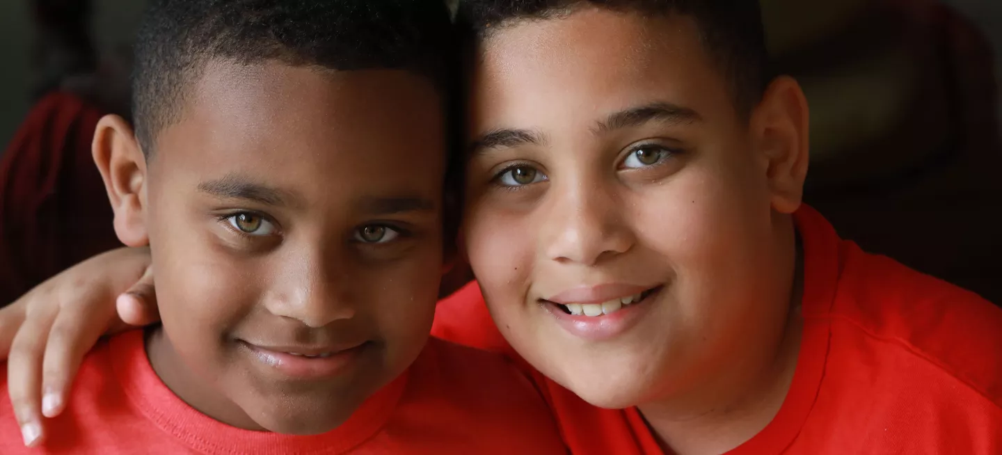Two boys smiling and enjoying their time together.