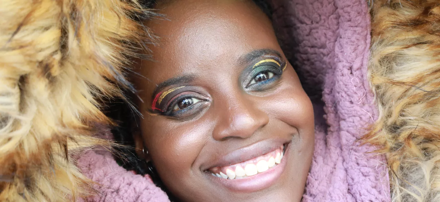 A young woman wearing a parka smiling