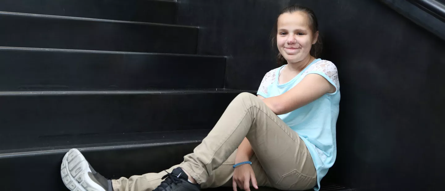 A young girl sitting on steps