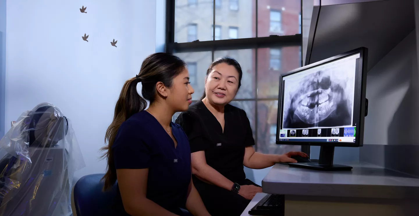Dr. Lee sitting beside a resident.