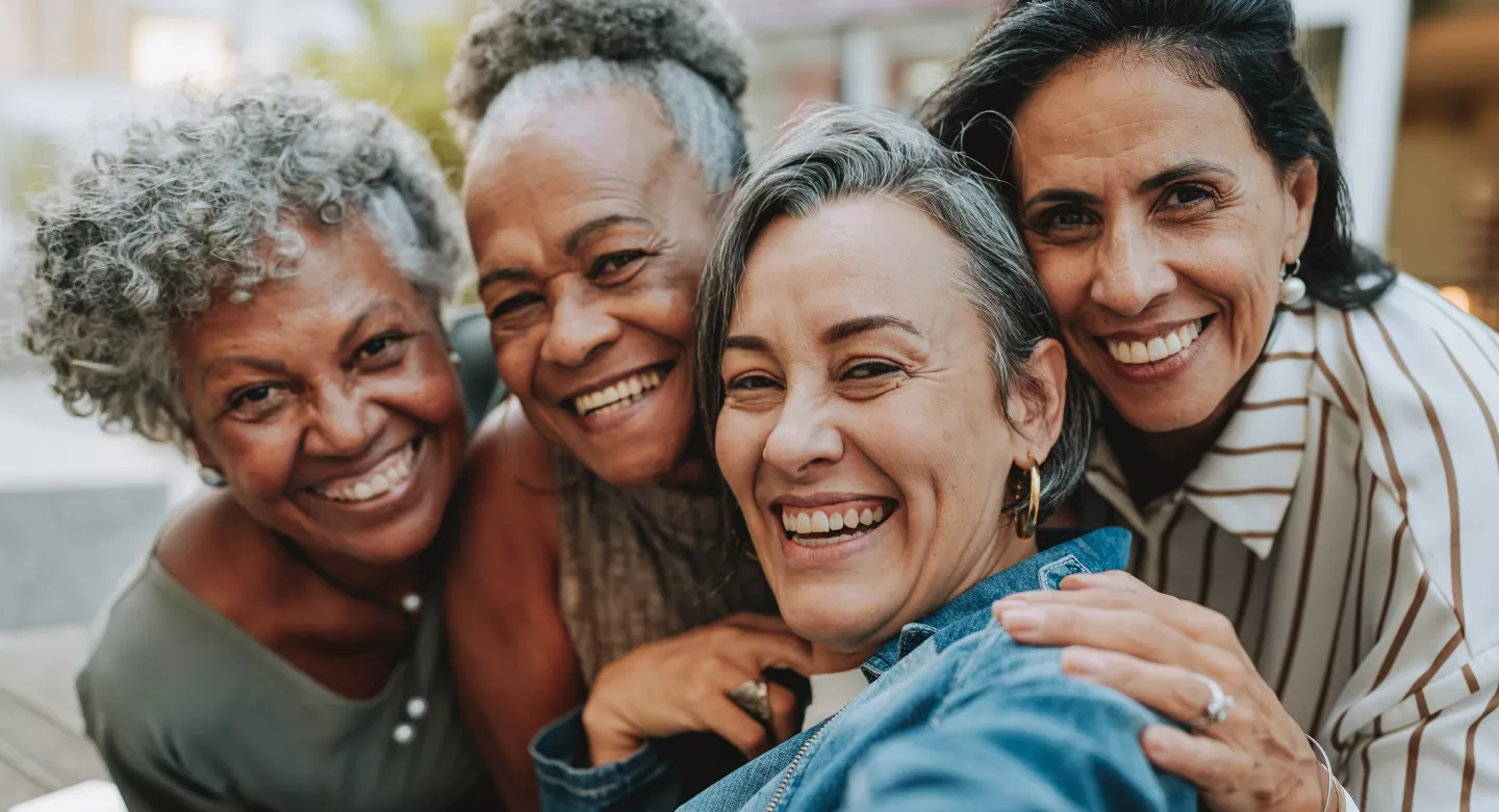 A group of women smiling while taking a selfie