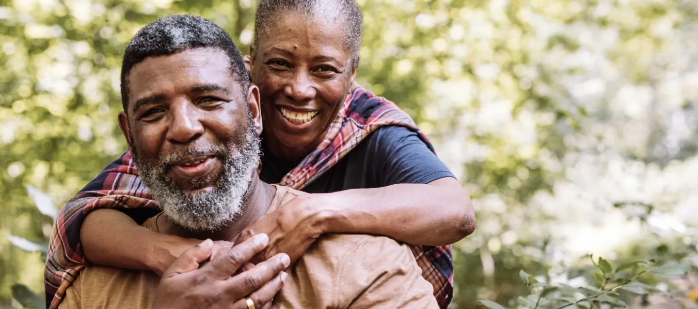 Woman hugging husband and smiling
