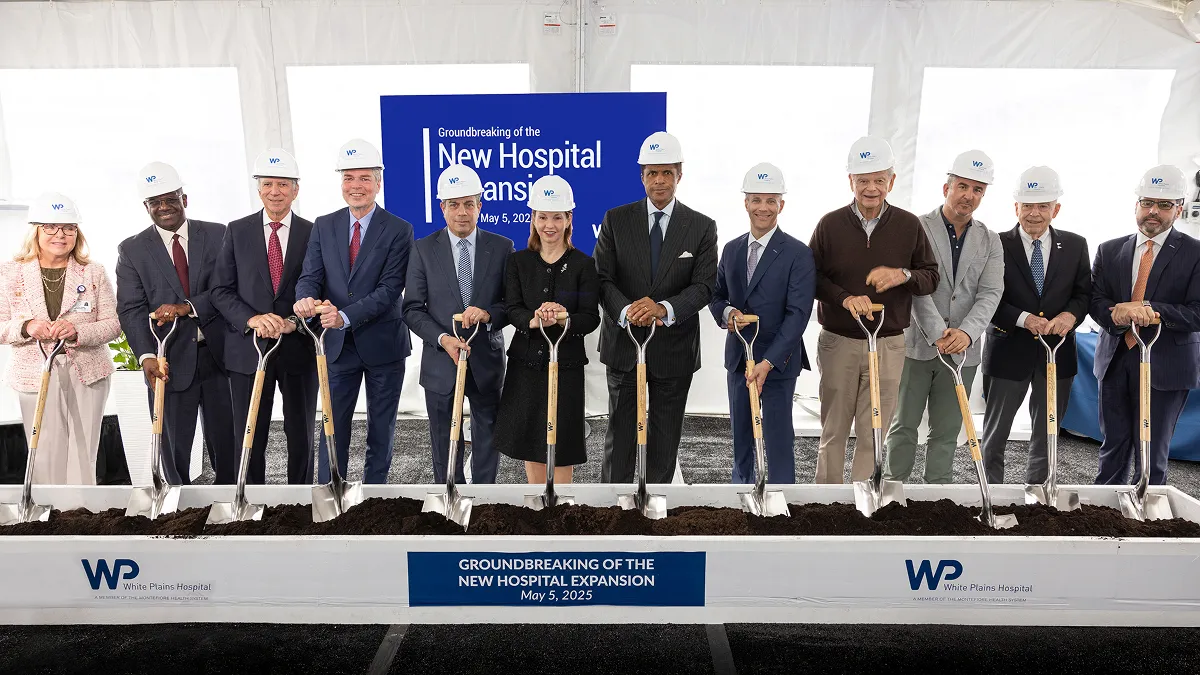 Montefiore Einstein leadership, including Philip O. Ozuah, MD, PhD, President and CEO, Montefiore Einstein, and Susan Fox, Regional Senior Vice President for the Hudson Valley, Montefiore Einstein, and President & CEO, White Plains Hospital, along with White Plains Hospital leadership, Westchester County Executive Ken Jenkins and White Plains Mayor Tom Roach, and other holding new shovels at a groundbreaking ceremony.