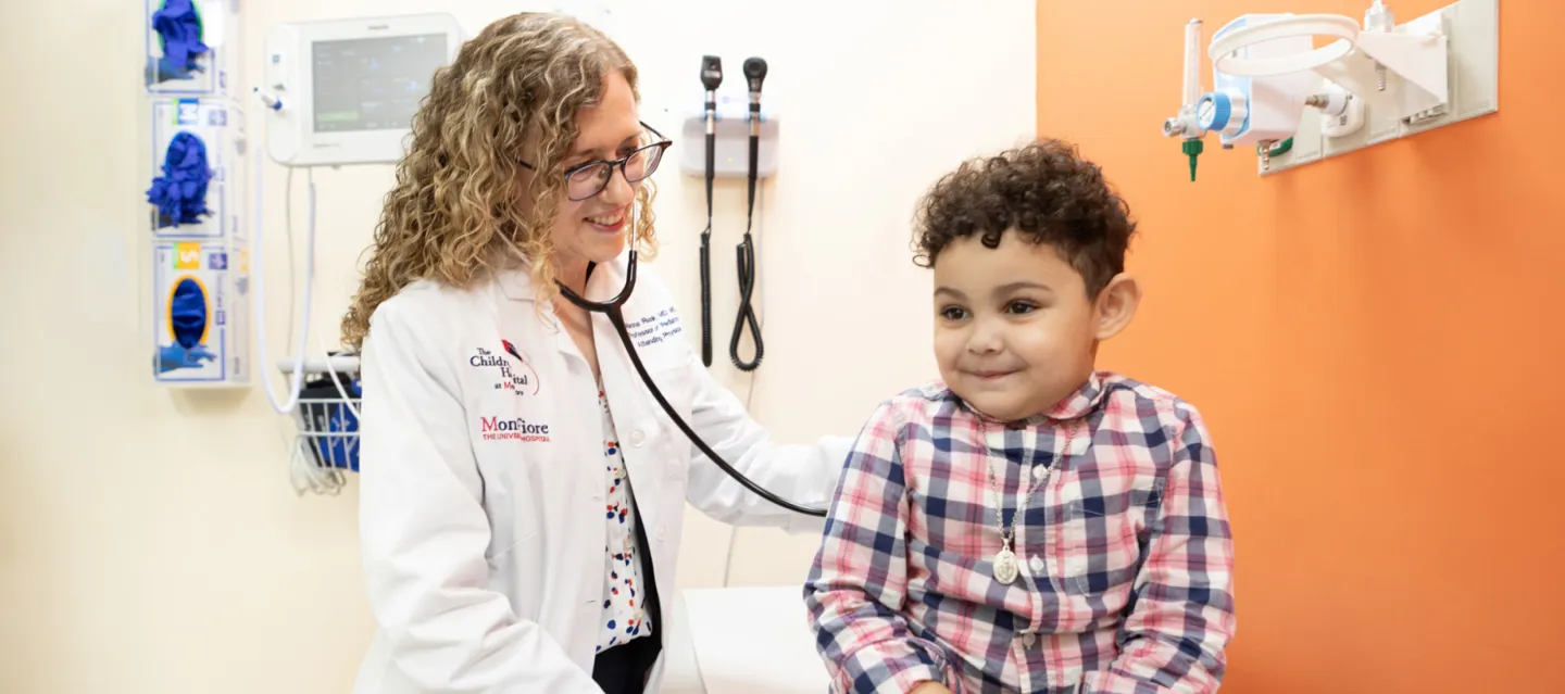 Doctor examining smiling child