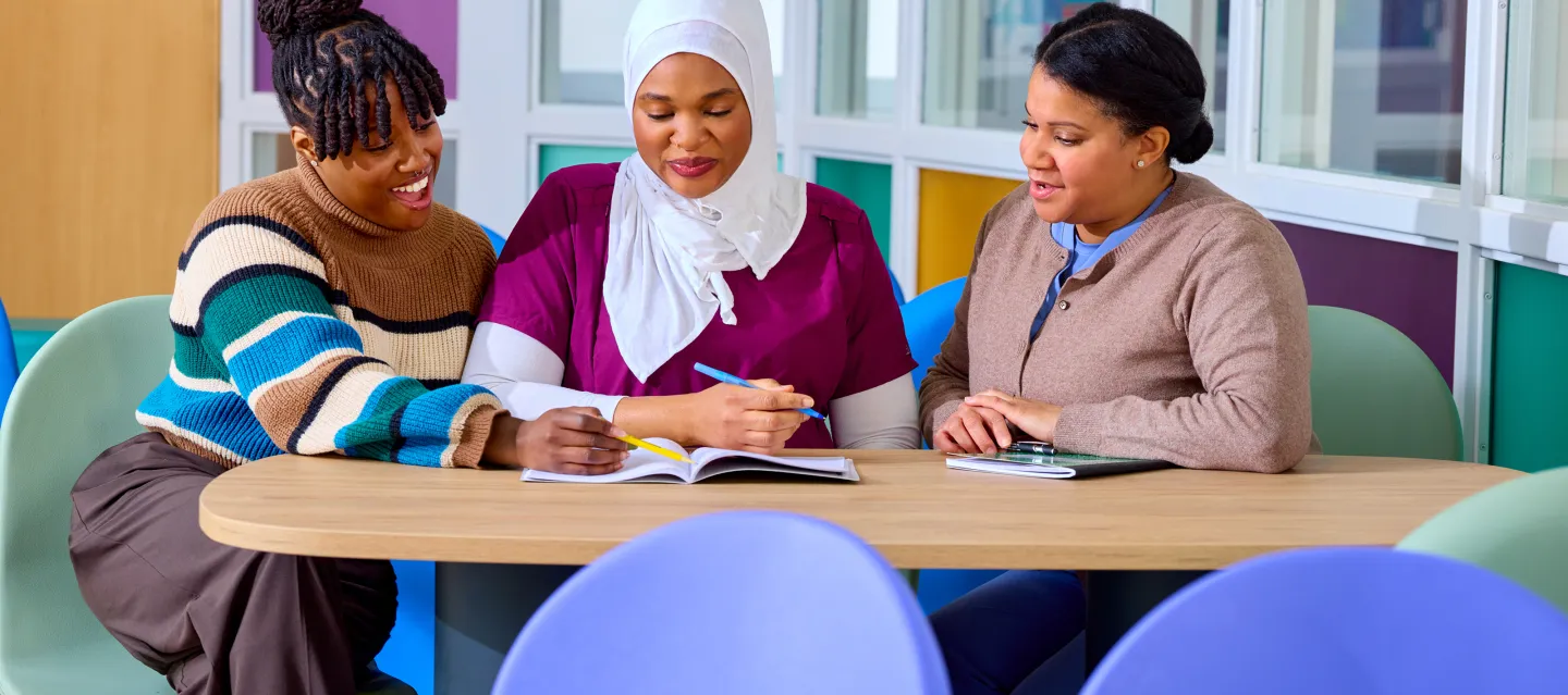 Team of three women sitting at at table