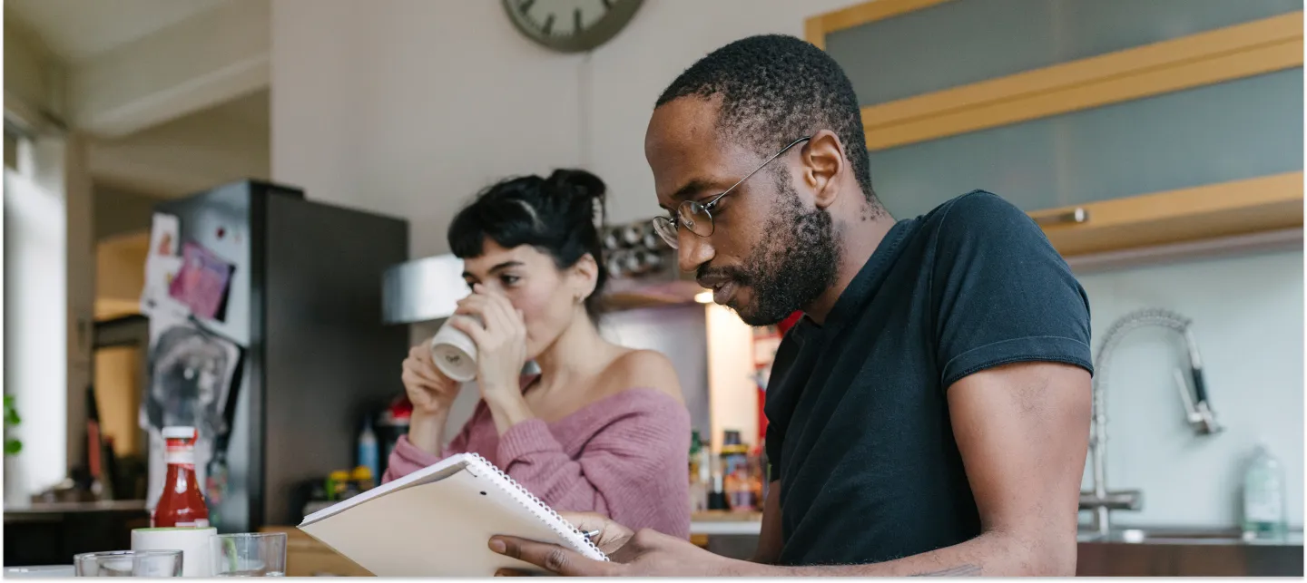 Two students study in a cozy kitchen