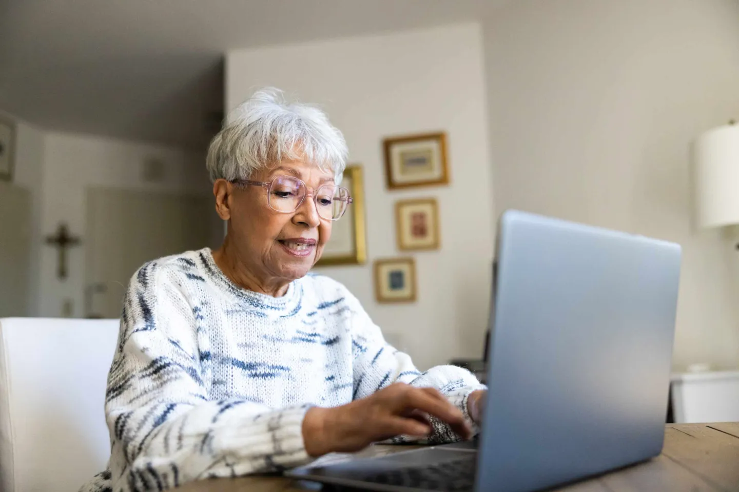 An elderly lady working on a laptop