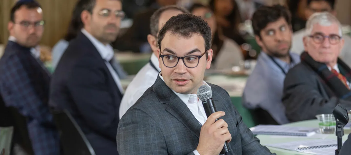 Ophthalmology alumni speaking on microphone at a conference
