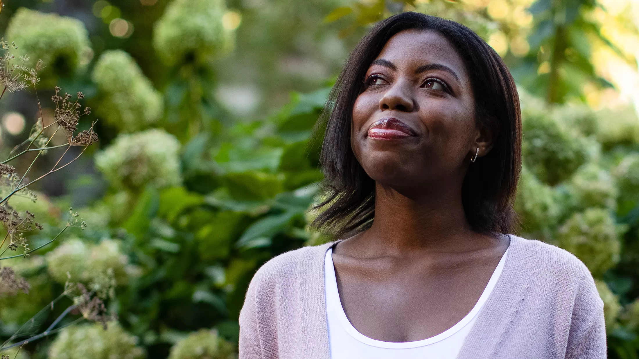 Erica standing in a garden